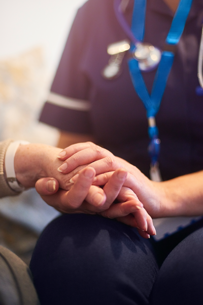 Nurse holding a hand